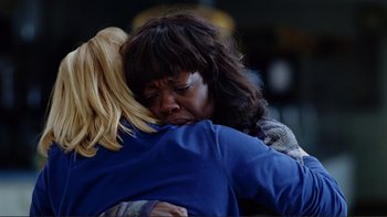 Movie still from “World Trade Center” (2006), directed by Oliver Stone – Two women are hugging each other in a room; Close Up shot, Over the shoulder angle