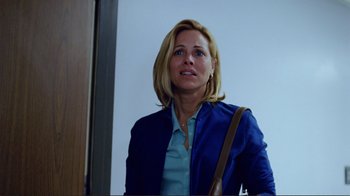 Movie still from “World Trade Center” (2006), directed by Oliver Stone – A woman in a blue jacket and a brown purse; Medium shot, Over the shoulder angle