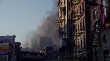 Movie still from “World Trade Center” (2006), directed by Oliver Stone – Smoke billows from a fire that has been set on a building; Extreme Wide shot, Low angle