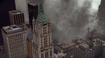 Movie still from “World Trade Center” (2006), directed by Oliver Stone – An aerial view of a large city with smoke billowing from it; Extreme Wide shot, Overhead angle