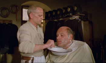 Movie still from “Woyzeck” (1979), directed by Werner Herzog – A man getting his head shaved by a barber; Medium shot, Over the shoulder angle
