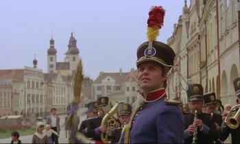 Movie still from “Woyzeck” (1979), directed by Werner Herzog – A man in a military uniform is holding a trumpet; Medium shot, Low angle