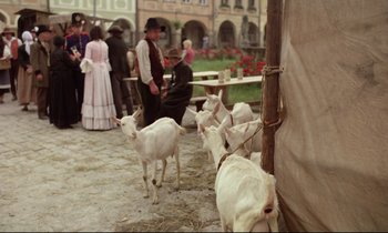 Movie still from “Woyzeck” (1979), directed by Werner Herzog – A group of people standing next to a group of goats; Wide shot, High angle