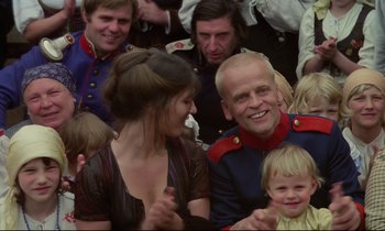 Movie still from “Woyzeck” (1979), directed by Werner Herzog – A group of people gathered around a man and a woman; Close Up shot, Low angle