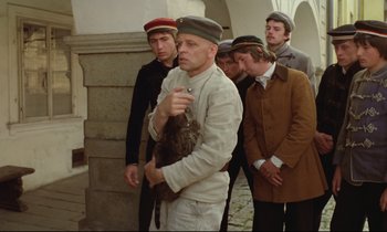 Movie still from “Woyzeck” (1979), directed by Werner Herzog – A group of men standing next to each other; Medium shot, Low angle