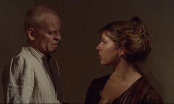 Movie still from “Woyzeck” (1979), directed by Werner Herzog – A man and a woman face to face in a dark room; Close Up shot, Over the shoulder angle
