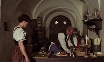 Movie still from “Woyzeck” (1979), directed by Werner Herzog – A man and a woman preparing food in a kitchen; Medium shot, High angle
