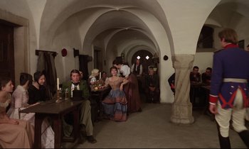 Movie still from “Woyzeck” (1979), directed by Werner Herzog – A group of people sitting at tables in a room; Wide shot, High angle