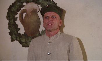 Movie still from “Woyzeck” (1979), directed by Werner Herzog – A man wearing a military uniform and a hat; Close Up shot, Low angle