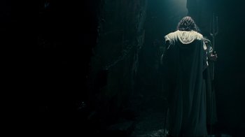 Movie still from “Wrath of the Titans” (2012), directed by Jonathan Liebesman – A man is walking through a dark alley; Wide shot, Over the shoulder angle