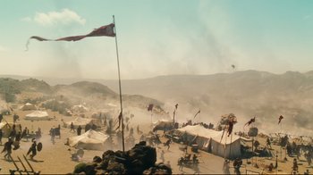 Movie still from “Wrath of the Titans” (2012), directed by Jonathan Liebesman – An image of a desert scene with tents and flags in the desert; Extreme Wide shot, Low angle