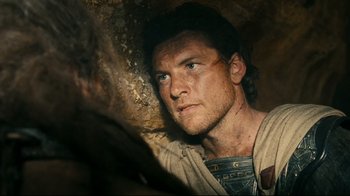 Movie still from “Wrath of the Titans” (2012), directed by Jonathan Liebesman – A person in a cave looking at the camera; Close Up shot, Over the shoulder angle