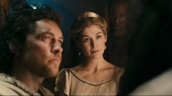 Movie still from “Wrath of the Titans” (2012), directed by Jonathan Liebesman – A man and a woman standing next to each other in front of another man; Close Up shot, Over the shoulder angle