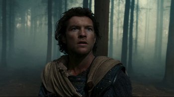 Movie still from “Wrath of the Titans” (2012), directed by Jonathan Liebesman – A person in a forest near trees; Close Up shot, Low angle
