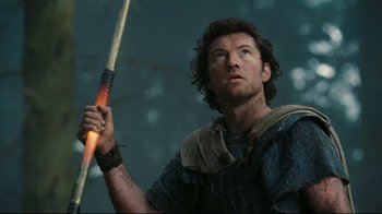 Movie still from “Wrath of the Titans” (2012), directed by Jonathan Liebesman – A person holding an arrow; Close Up shot, Low angle