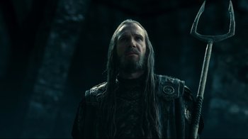 Movie still from “Wrath of the Titans” (2012), directed by Jonathan Liebesman – A man with long black hair and a beard; Close Up shot, Low angle