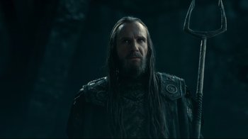 Movie still from “Wrath of the Titans” (2012), directed by Jonathan Liebesman – A man with long hair and a beard wearing a black jacket; Close Up shot, Low angle