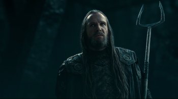 Movie still from “Wrath of the Titans” (2012), directed by Jonathan Liebesman – A man with long black hair and a beard; Close Up shot, Low angle