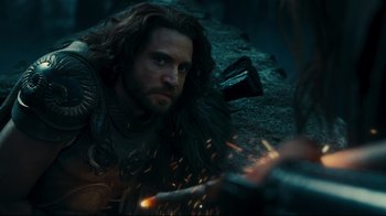 Movie still from “Wrath of the Titans” (2012), directed by Jonathan Liebesman – A person with a sword; Medium shot, Over the shoulder angle