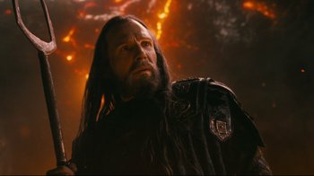 Movie still from “Wrath of the Titans” (2012), directed by Jonathan Liebesman – A man with long black hair wearing a black jacket; Close Up shot, Low angle
