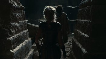 Movie still from “Wrath of the Titans” (2012), directed by Jonathan Liebesman – A woman in a black dress is walking down the stairs; Wide shot, Low angle