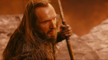Movie still from “Wrath of the Titans” (2012), directed by Jonathan Liebesman – A man with long hair and a beard holding a spear; Close Up shot, Low angle