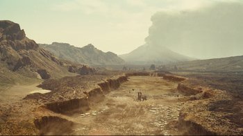 Movie still from “Wrath of the Titans” (2012), directed by Jonathan Liebesman – An image of an open field with a volcano in the background; Extreme Wide shot, High angle