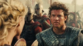 Movie still from “Wrath of the Titans” (2012), directed by Jonathan Liebesman – A group of men in helmets and body armor standing next to each other; Close Up shot, Over the shoulder angle