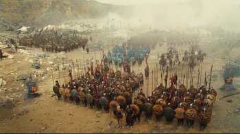 Movie still from “Wrath of the Titans” (2012), directed by Jonathan Liebesman – A large group of people are gathered in the sand; Extreme Wide shot, High angle