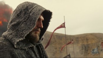 Movie still from “Wrath of the Titans” (2012), directed by Jonathan Liebesman – A bearded man wearing a hooded jacket and a long coat; Medium shot, Low angle