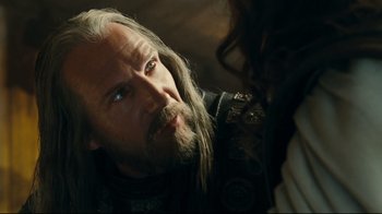 Movie still from “Wrath of the Titans” (2012), directed by Jonathan Liebesman – A man with long white hair and a long beard; Close Up shot, Over the shoulder angle