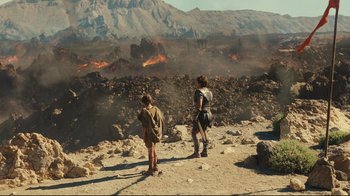 Movie still from “Wrath of the Titans” (2012), directed by Jonathan Liebesman – A couple of people standing on top of a dirt hill; Extreme Wide shot, High angle