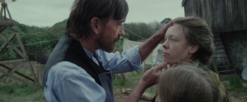 Movie still from “Apostle” (2018), directed by Gareth Evans – A man and a woman are looking at each other in a field; Close Up shot, Over the shoulder angle