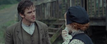 Movie still from “Apostle” (2018), directed by Gareth Evans – A man and a woman talking to each other outside; Close Up shot, Over the shoulder angle