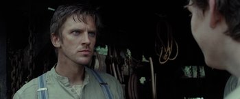 Movie still from “Apostle” (2018), directed by Gareth Evans – A person wearing a shirt; Close Up shot, Low angle