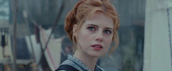 Movie still from “Apostle” (2018), directed by Gareth Evans – A person wearing a dress; Close Up shot, Over the shoulder angle