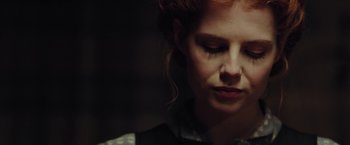 Movie still from “Apostle” (2018), directed by Gareth Evans – A person wearing a dress; Close Up shot, Low angle