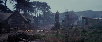 Movie still from “Apostle” (2018), directed by Gareth Evans – A statue of a person in a graveyard; Extreme Wide shot, Low angle