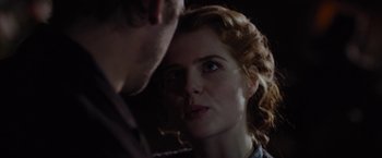 Movie still from “Apostle” (2018), directed by Gareth Evans – A woman's face and a man's face; Close Up shot, Over the shoulder angle