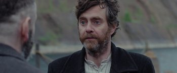 Movie still from “Apostle” (2018), directed by Gareth Evans – A person with a beard; Close Up shot, Over the shoulder angle