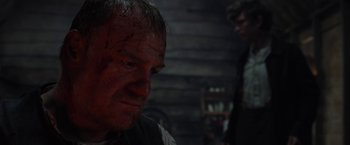 Movie still from “Apostle” (2018), directed by Gareth Evans – A person looking at the camera; Close Up shot, Over the shoulder angle