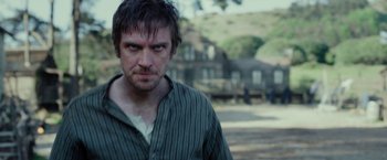 Movie still from “Apostle” (2018), directed by Gareth Evans – A person wearing a striped shirt; Close Up shot, Over the shoulder angle