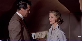 Movie still from “Written on the Wind” (1956), directed by Douglas Sirk – A man and a woman standing next to each other; Medium shot, Low angle