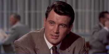 Movie still from “Written on the Wind” (1956), directed by Douglas Sirk – A person wearing a suit and tie; Close Up shot, Low angle