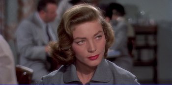 Movie still from “Written on the Wind” (1956), directed by Douglas Sirk – A person wearing a suit and tie; Close Up shot, Over the shoulder angle