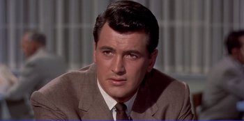 Movie still from “Written on the Wind” (1956), directed by Douglas Sirk – A person wearing a suit and tie; Close Up shot, Low angle