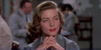 Movie still from “Written on the Wind” (1956), directed by Douglas Sirk – A person wearing a suit; Close Up shot, Over the shoulder angle