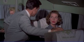 Movie still from “Written on the Wind” (1956), directed by Douglas Sirk – A man and a woman are looking at each other; Medium shot, Over the shoulder angle