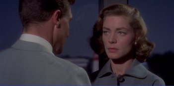 Movie still from “Written on the Wind” (1956), directed by Douglas Sirk – A man and a woman looking at one another; Close Up shot, Over the shoulder angle