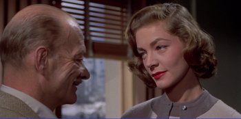 Movie still from “Written on the Wind” (1956), directed by Douglas Sirk – An older man and a younger woman looking at each other; Close Up shot, Over the shoulder angle